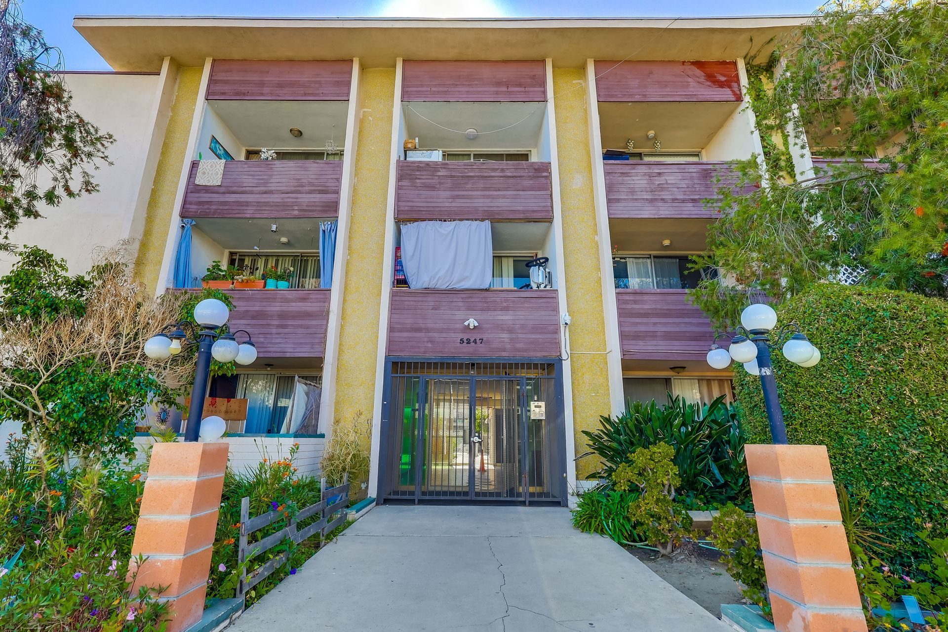 A large apartment building with a brick walkway leading to it