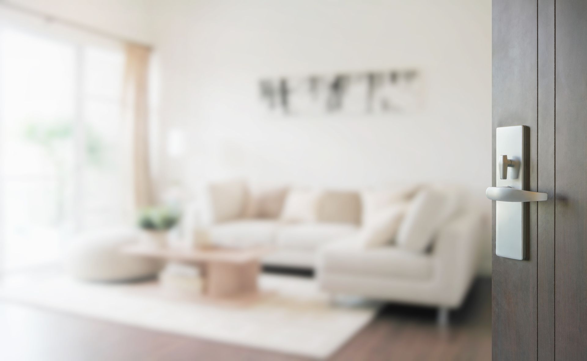 A blurred image of a living room with a couch and a coffee table.
