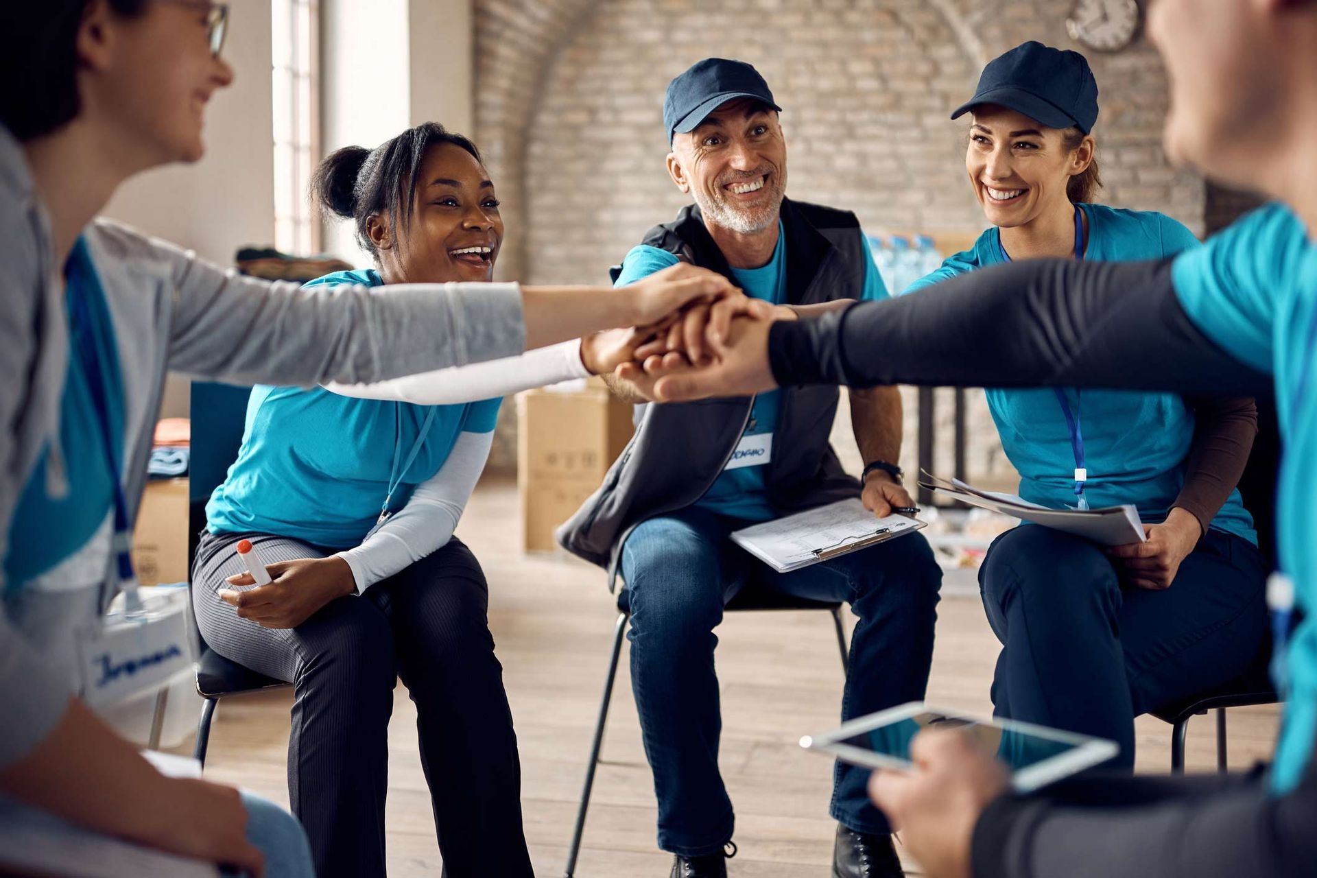 Team Of Motivated Volunteers Gathering Hands In Unity After Successful Meeting — Placida, FL — Accounting 4 Profitability LLC