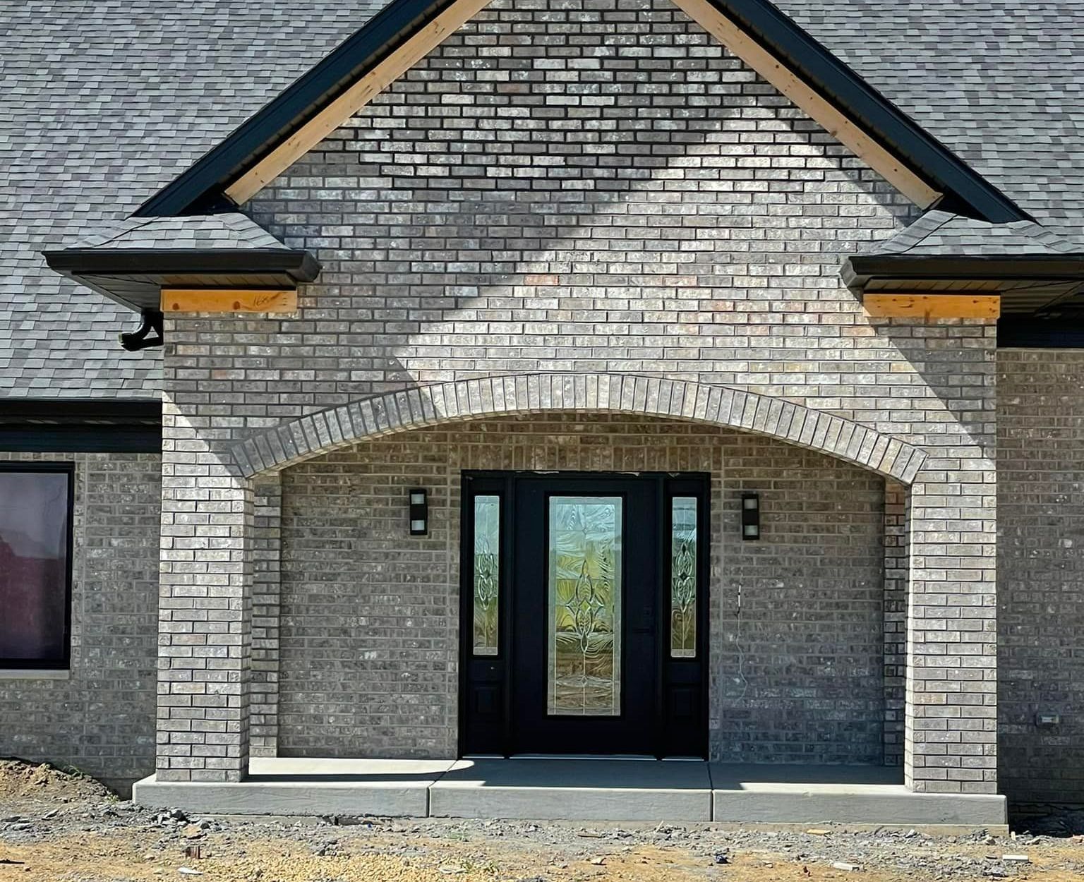 Brick House with a Red Door – Moline, IL –  QCFI Concrete & Masonry