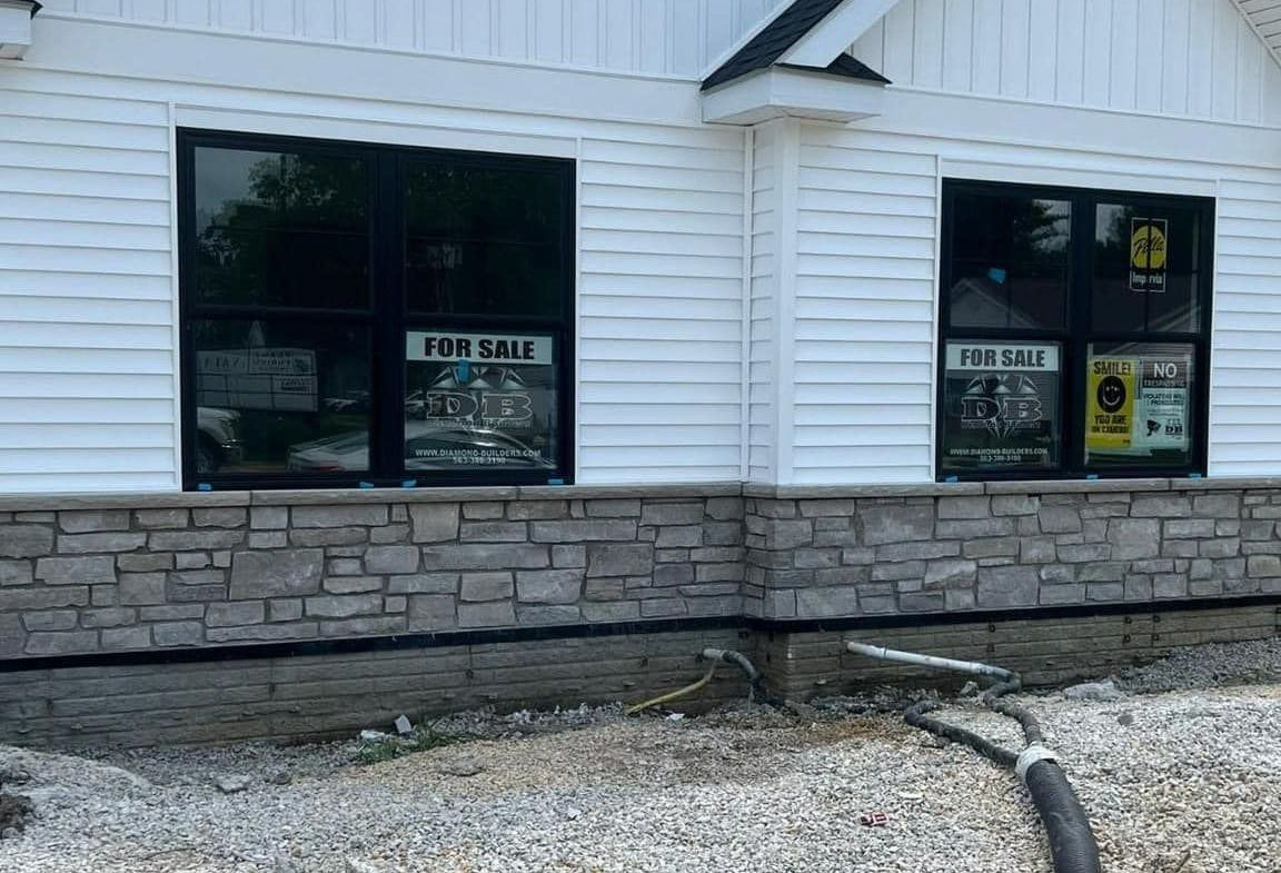 House with a Wooden Door and a Stone Wall – Moline, IL –  QCFI Concrete & Masonry