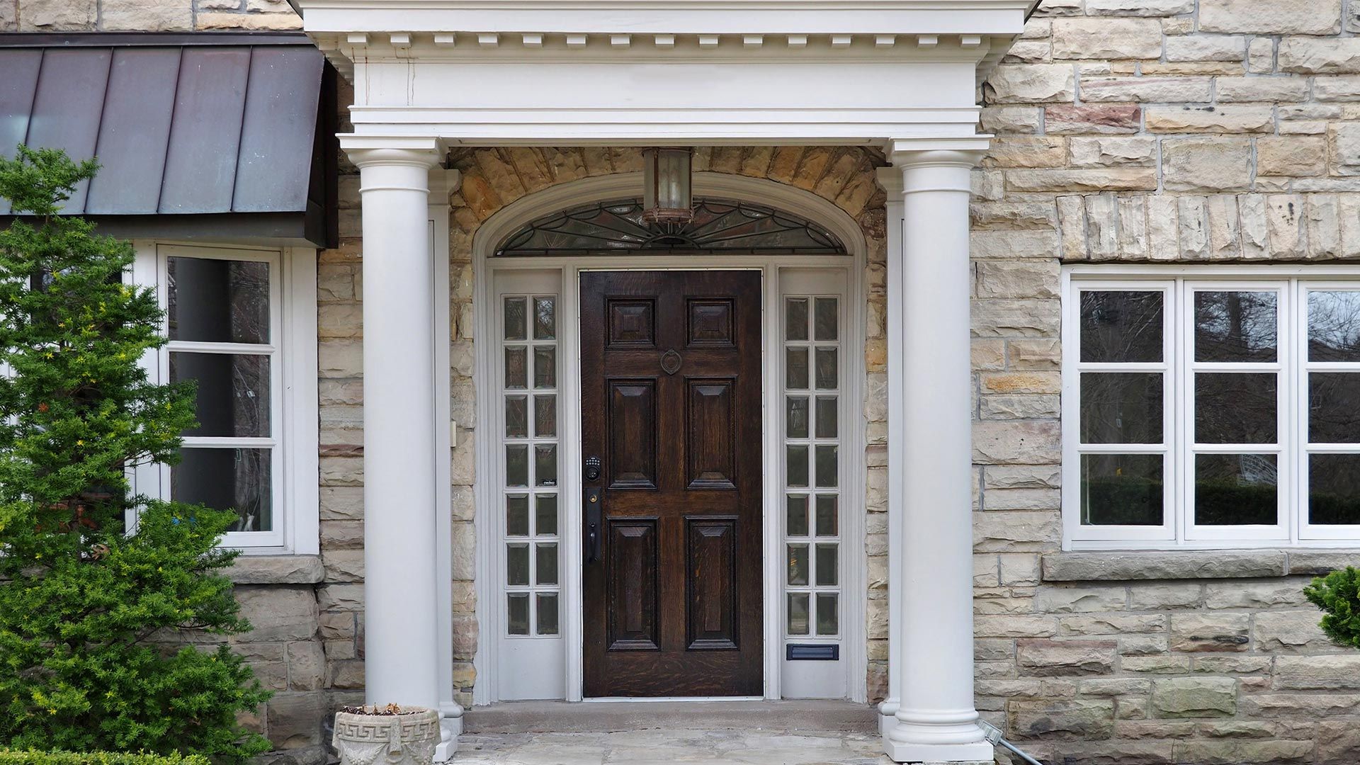 Brick House with a Porch and White Column – Moline, IL –  QCFI Concrete & Masonry