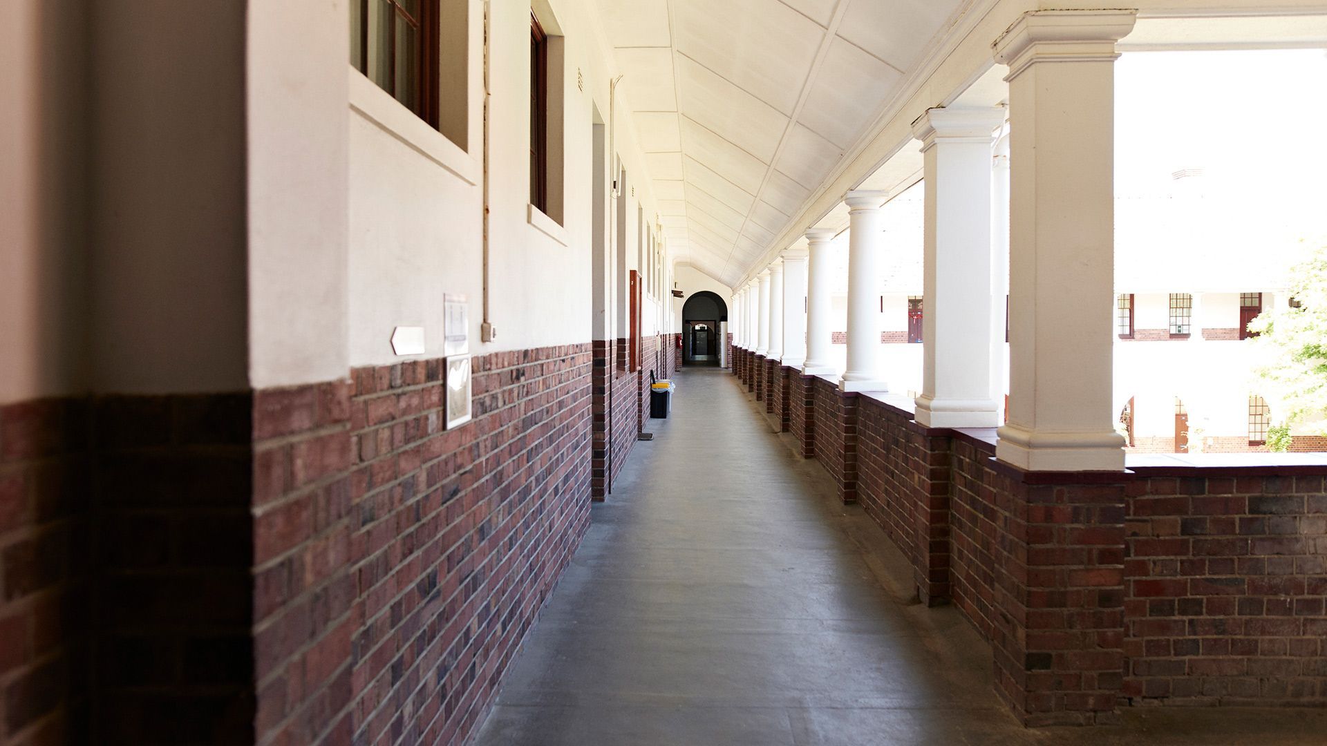 Hallway with Brick Walls and White Pillars – Moline, IL –  QCFI Concrete & Masonry