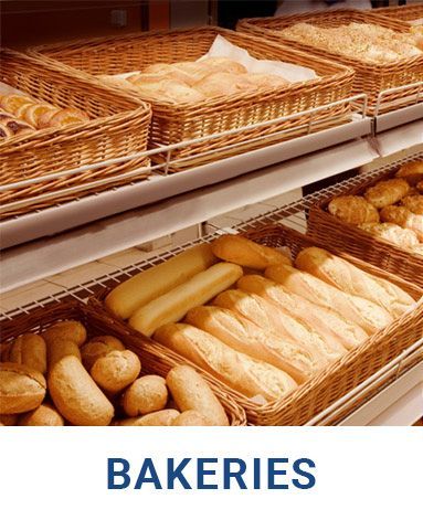 A bunch of baskets of bread are on a shelf in a bakery.