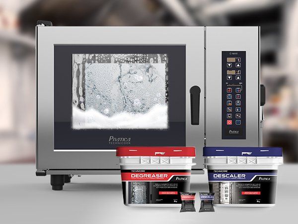 A microwave oven is sitting on a counter next to a container that says descaler
