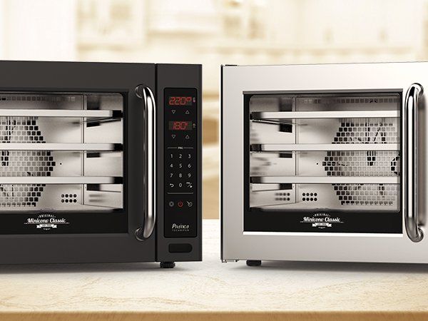 Two microwave ovens are sitting side by side on a counter