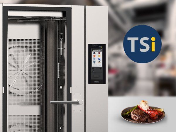 A plate of food is on a table next to a tsi logo