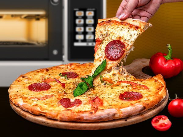 A person is taking a slice of pizza from a pizza on a wooden cutting board.