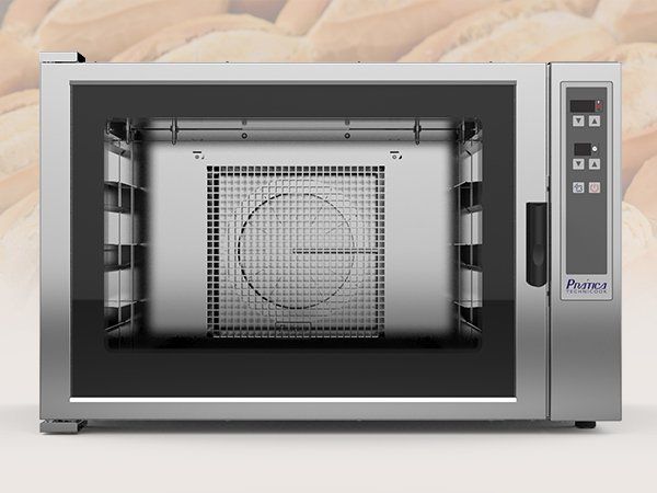 A stainless steel oven is sitting in front of a pile of bread