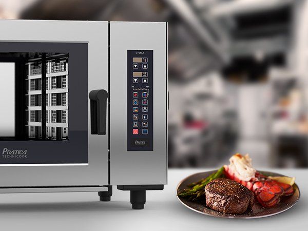 A plate of food is sitting next to a microwave oven.