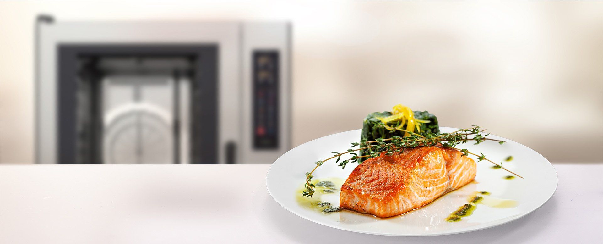 A plate of food is sitting on a table in front of a microwave.