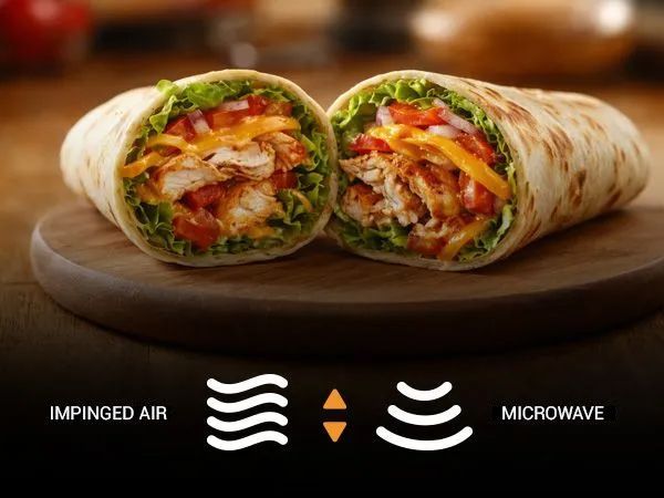 A bowl of chicken wings is sitting on a table next to celery and a glass of beer.