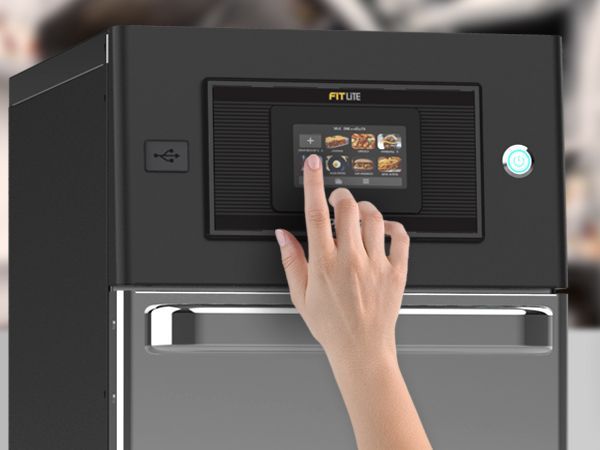 A woman 's hand is pressing a button on a machine