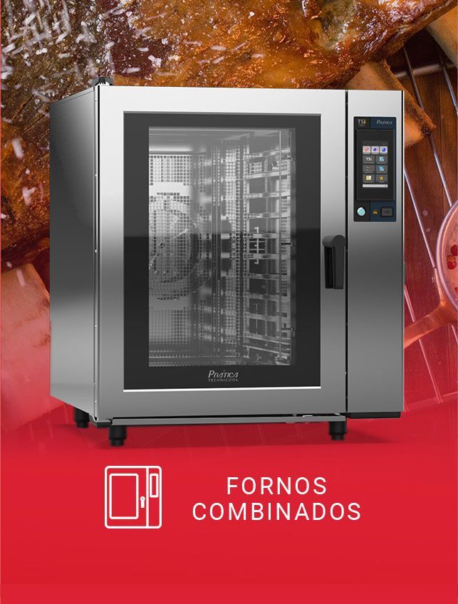 A stainless steel combi oven is sitting on top of a red table.