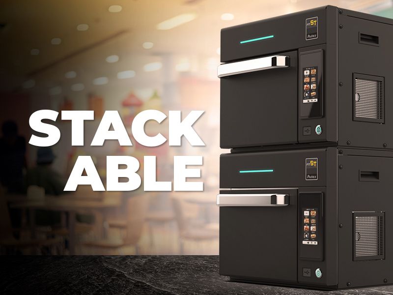 Two stackable ovens are sitting on top of each other on a counter.