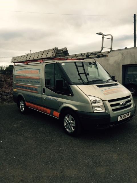 Angled shot of the silver Capital Roofing Services van