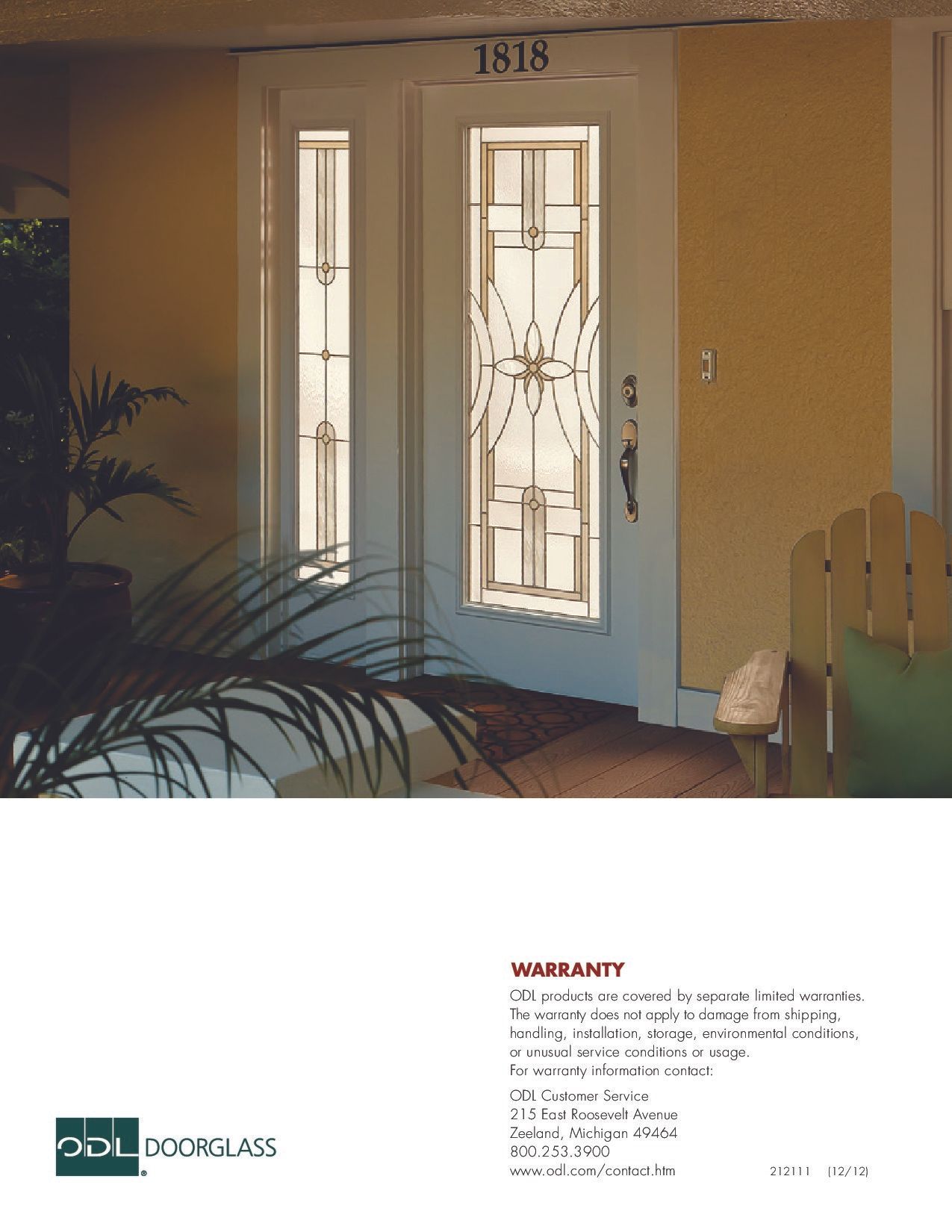 White door with stained glass design; entrance to a yellow building.