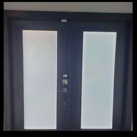 Black double doors with frosted glass panels.