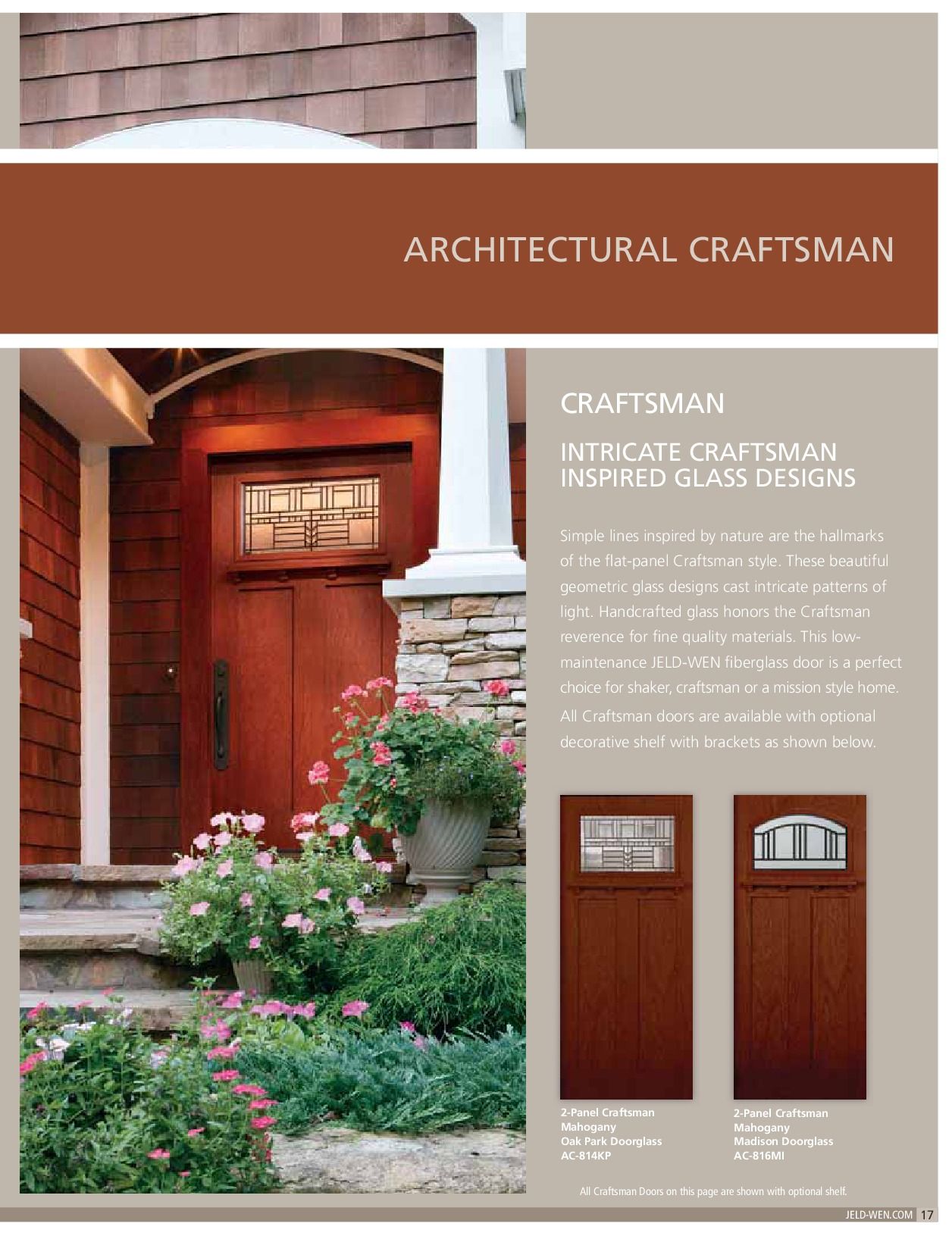 Craftsman-style entryway with reddish-brown door, sidelight, and brick and stone accents. Flowers and greenery.
