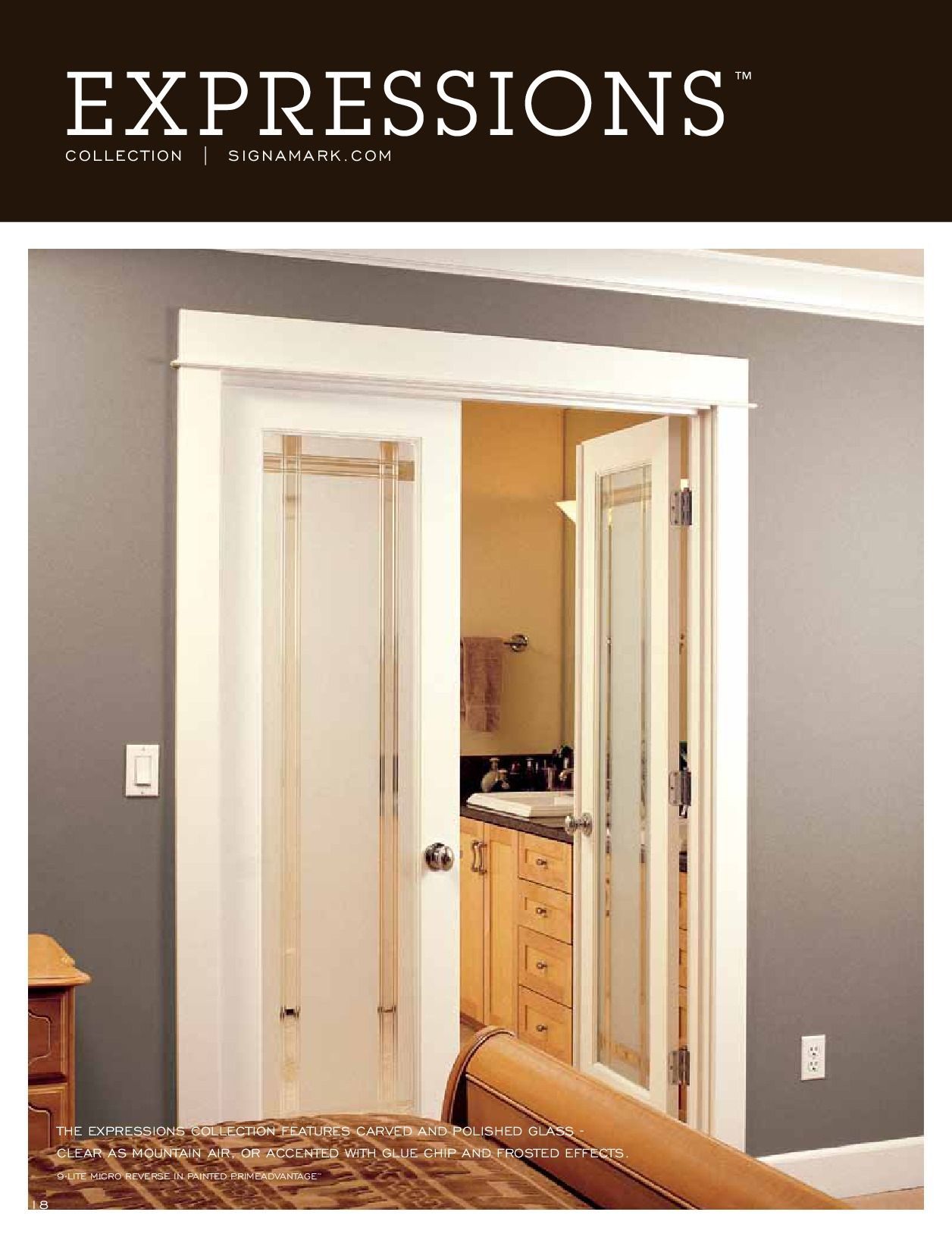 White-framed, frosted glass doors open to a bathroom with light wood cabinets and a tan wall; the bedroom has a gray wall.