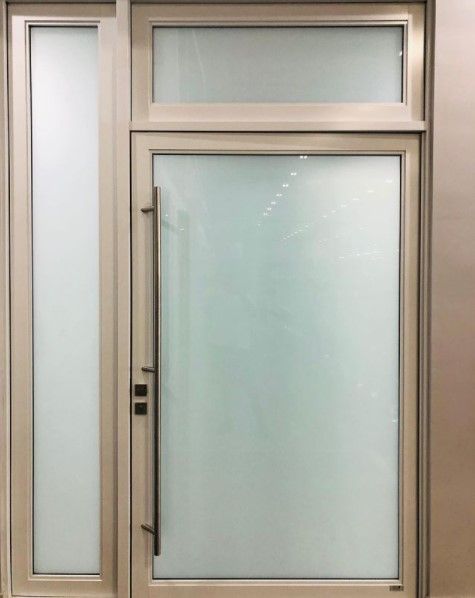 Frosted glass entry door with sidelight and transom window, in a tan frame.