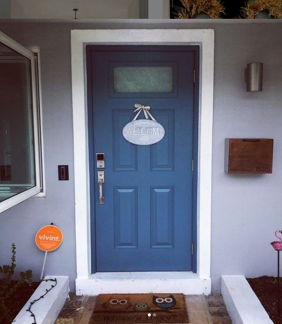 Blue front door with white trim, 
