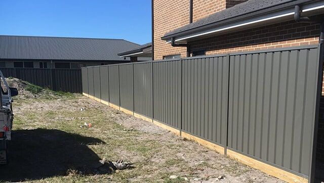 A White Fence Along a Sidewalk next to a House — Fencing in Port Stephens, NSW