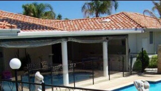 A Black Fence is Surrounding a House on a Sidewalk — Fencing in Port Stephens, NSW