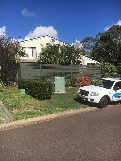 A White Truck is Parked in Front of a House — Fencing in Port Stephens, NSW