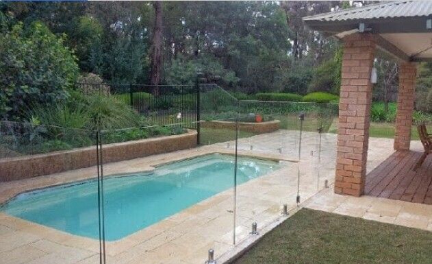 A Large Swimming Pool Surrounded by a Glass fence in a Backyard — Fencing in Port Stephens, NSW