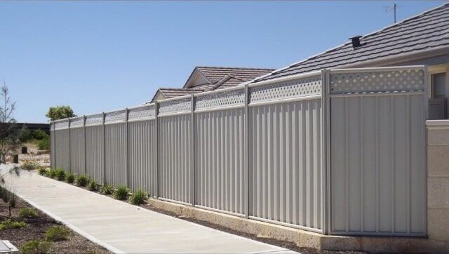 A White Fence Along a Sidewalk next to a House — Fencing in Port Stephens, NSW