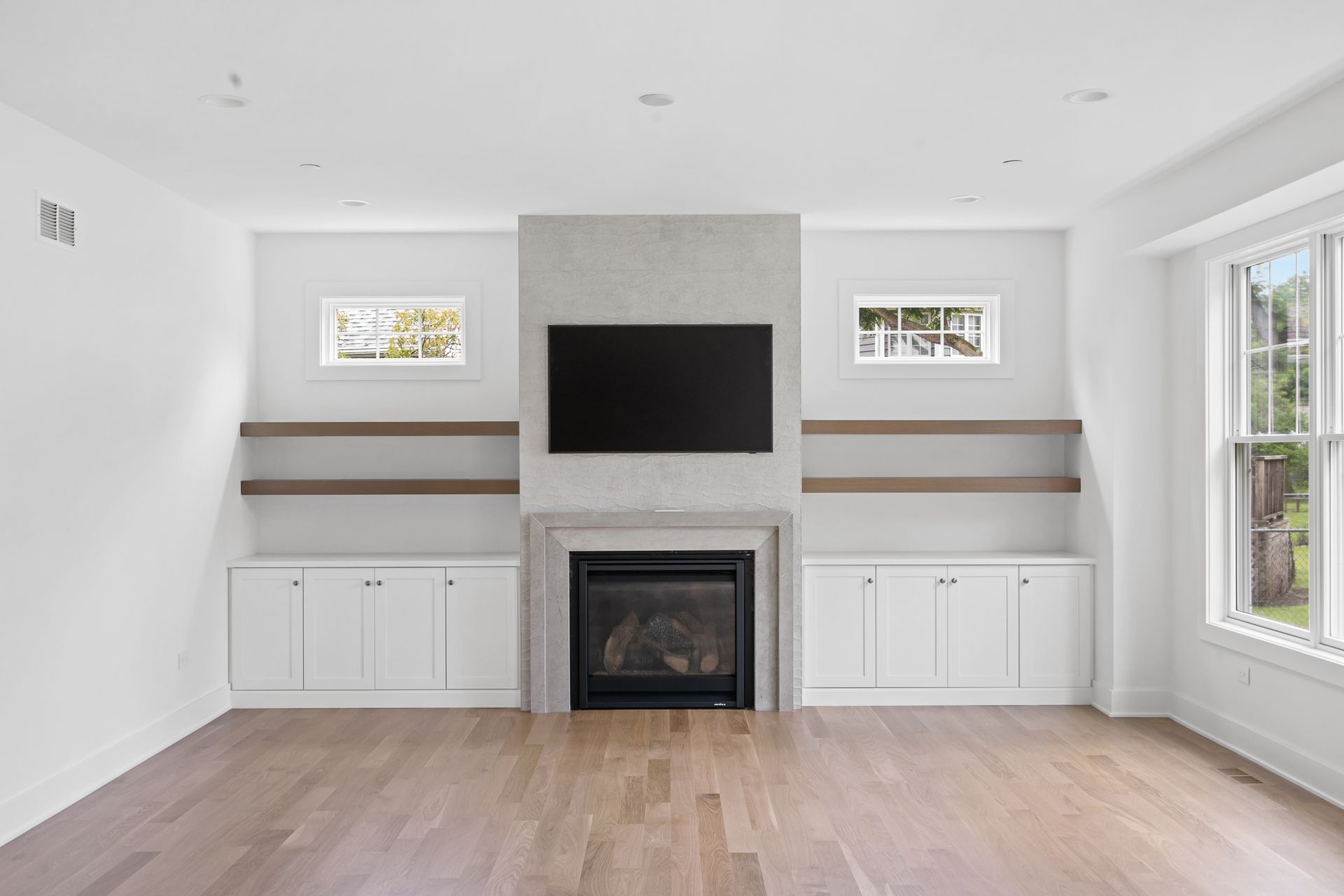 A living room with a fireplace and a flat screen tv.