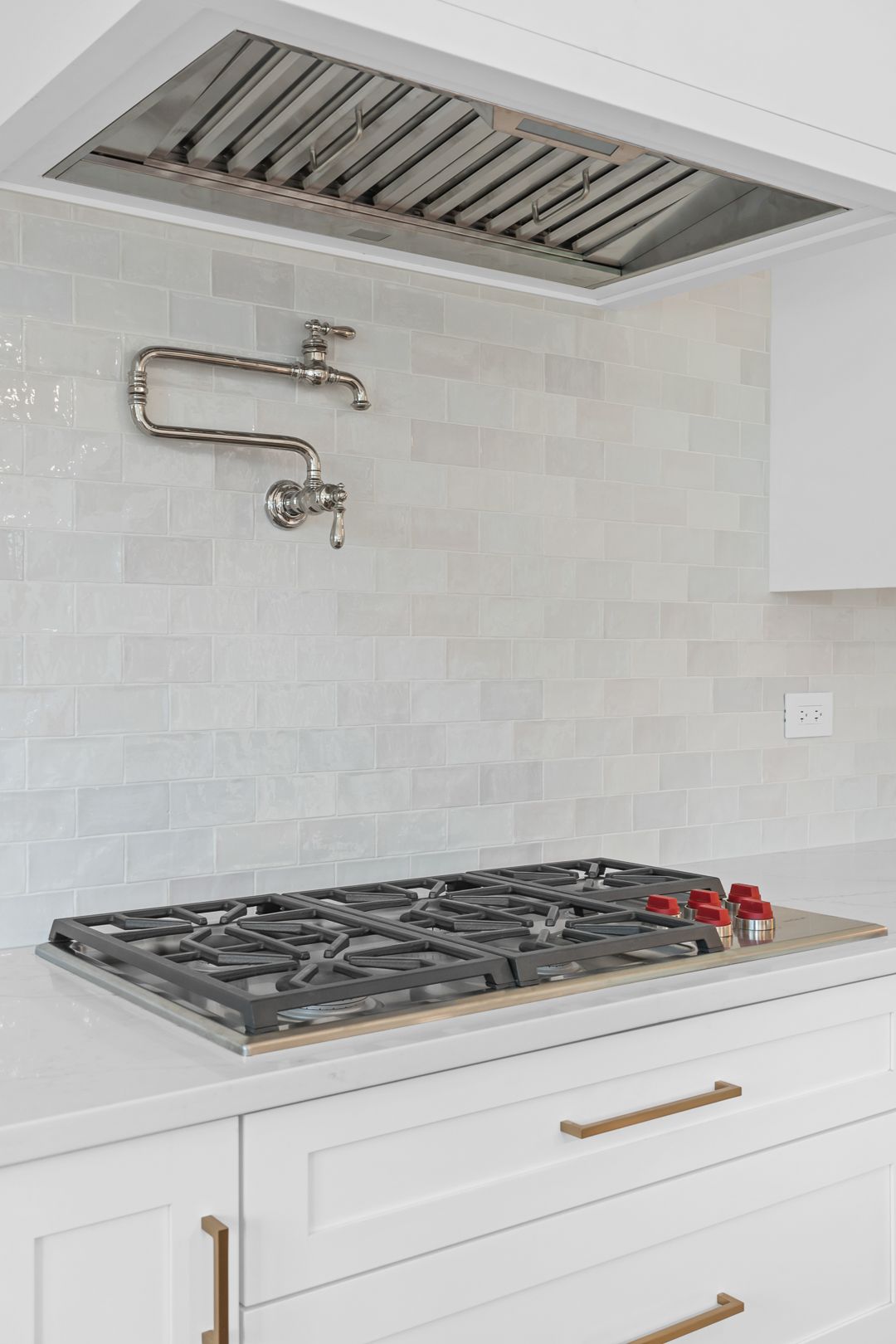 A stove top oven is sitting on top of a white counter in a kitchen.