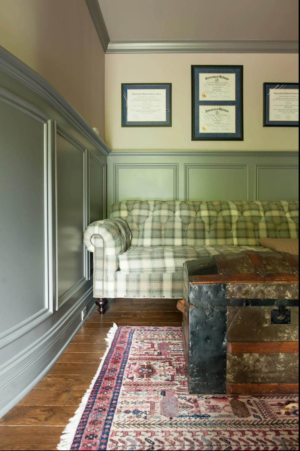 A living room with a couch and a trunk