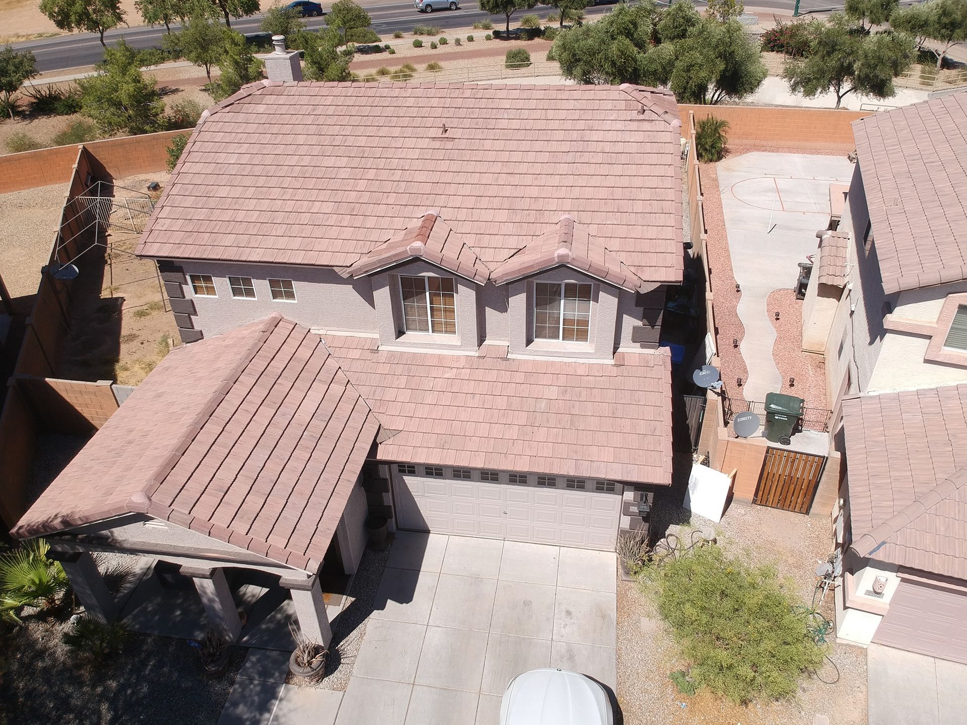 Overhead view of a two-story house with a red-tiled roof and attached garage.