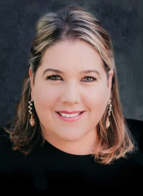 Smiling woman in a black top against a dark studio background