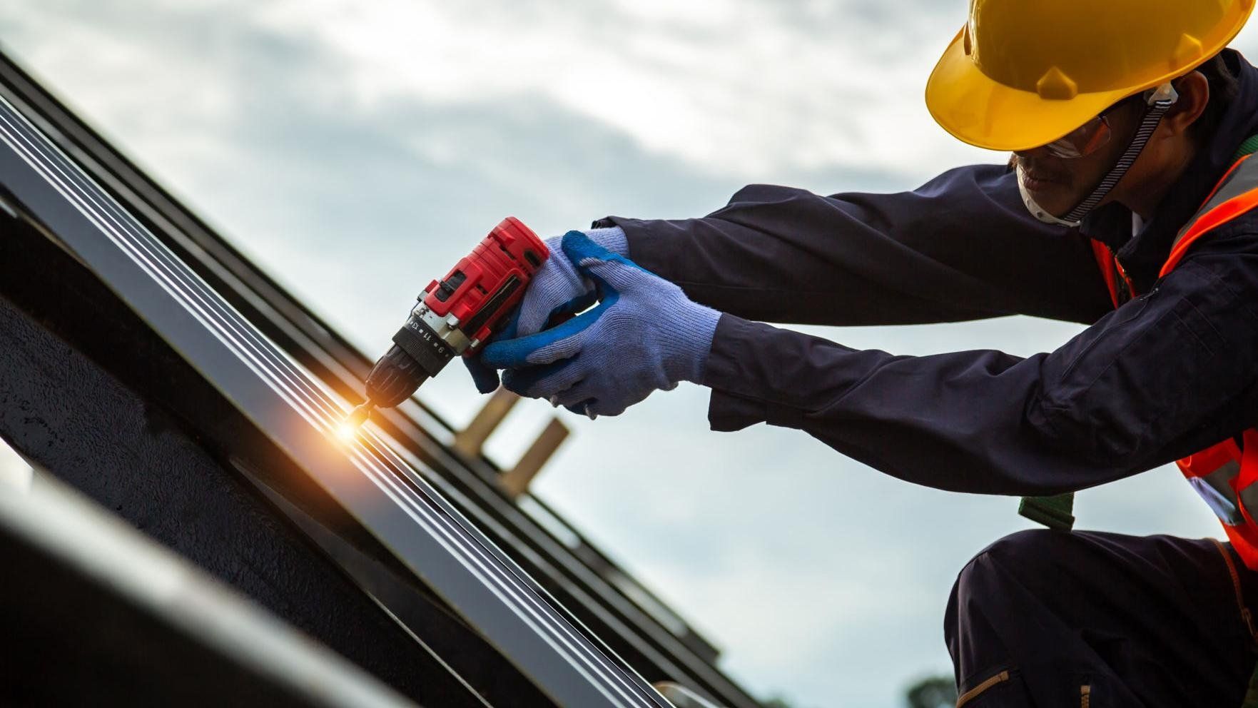 Roofer worker in protective uniform wear and gloves repair