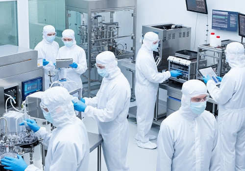 Automated system sorting green pharmaceutical capsules on a production line.
