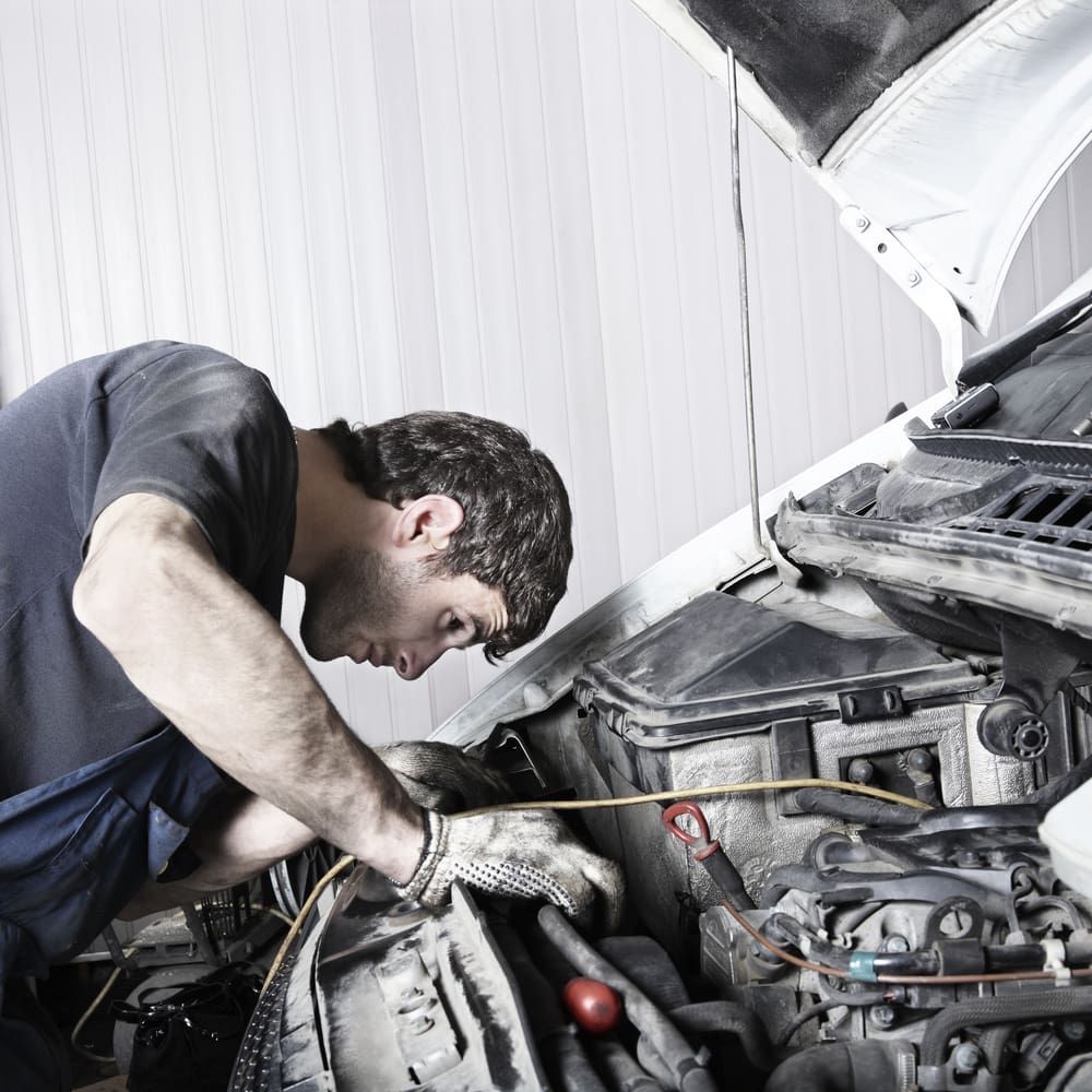 A Professional Man is Working Under the Hood of a Car — Hancock Automotive in Bennetts Green, NSW