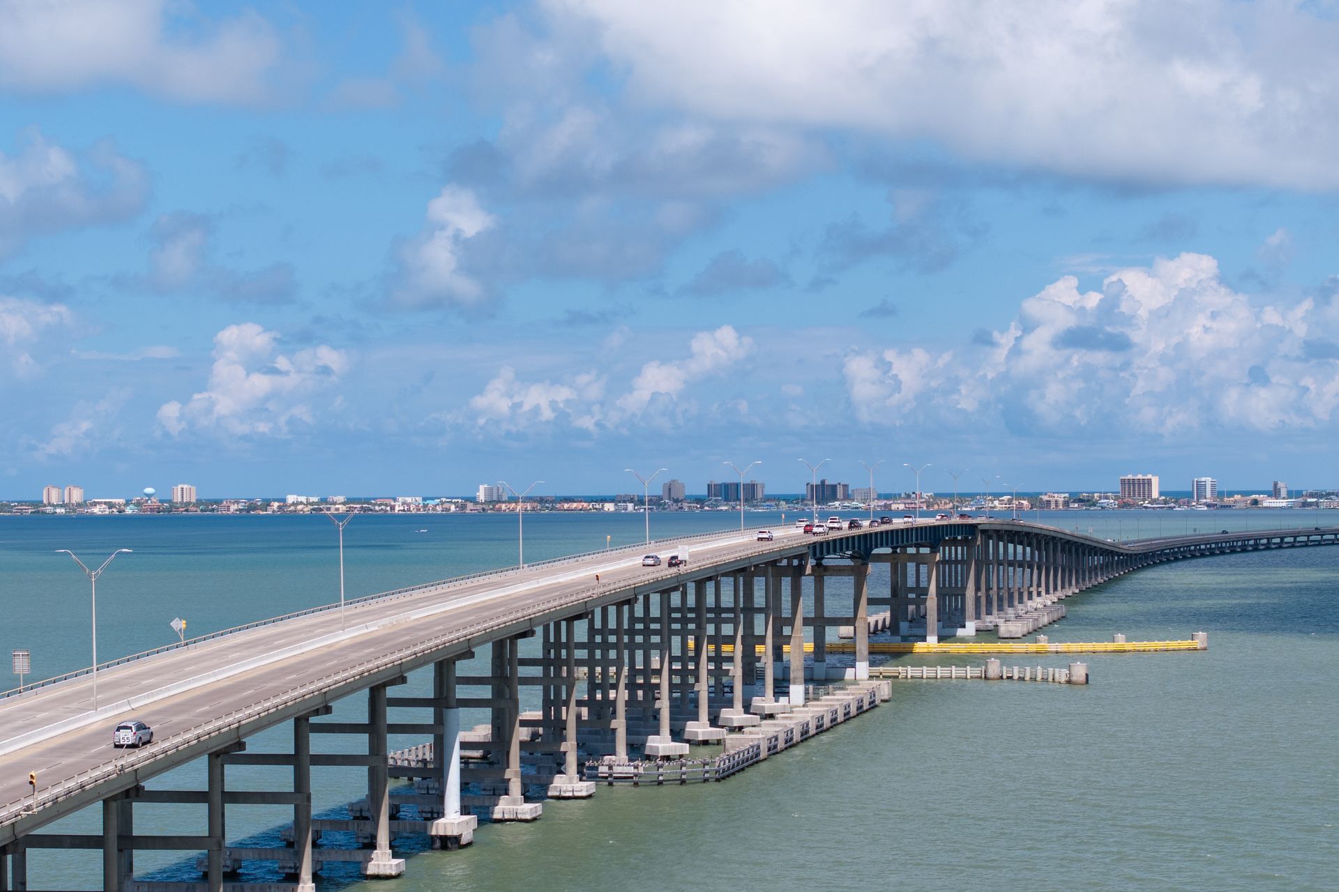 An aerial view of a bridge over a body of water.