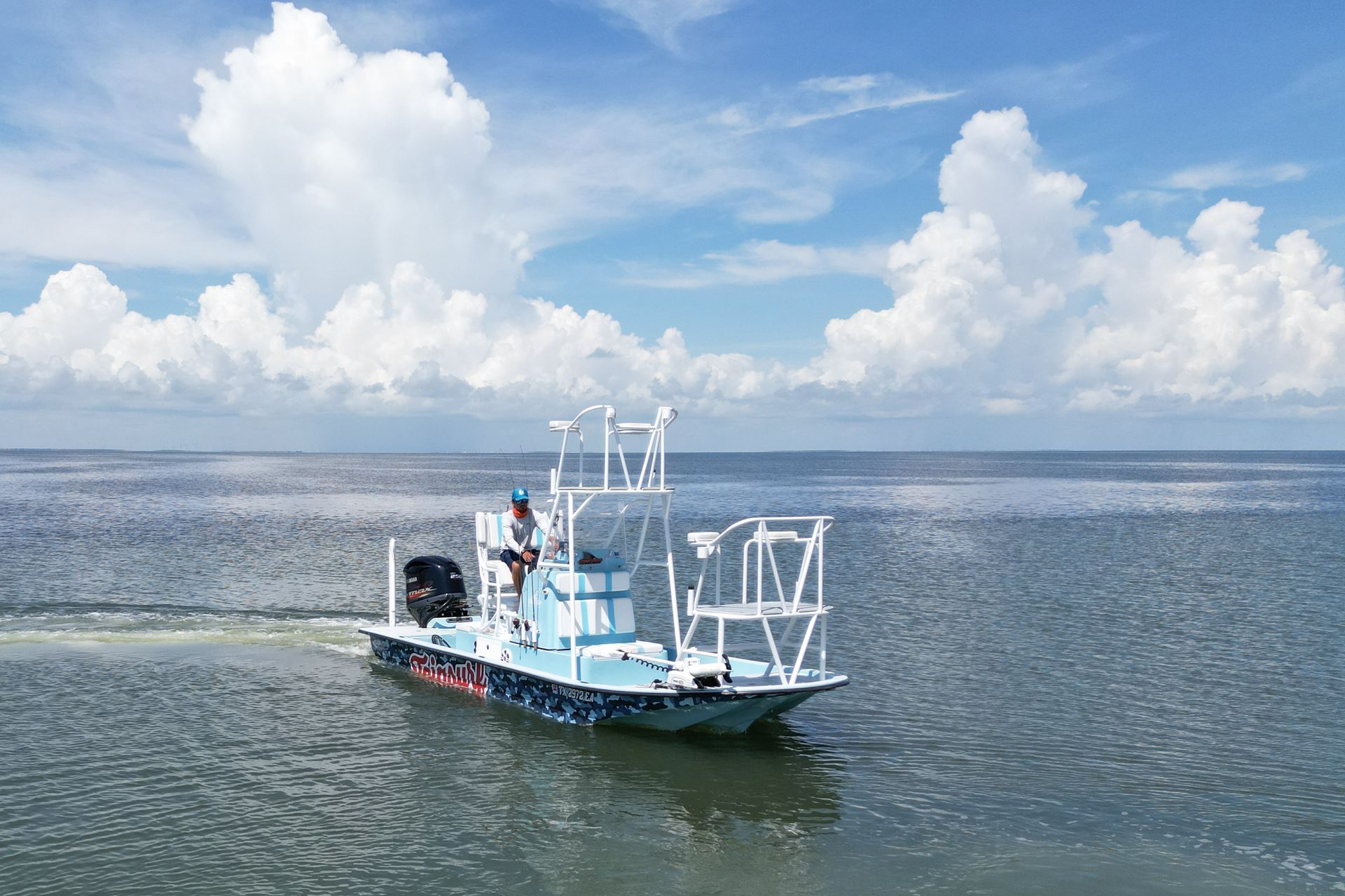 A small boat is floating on top of a large body of water.