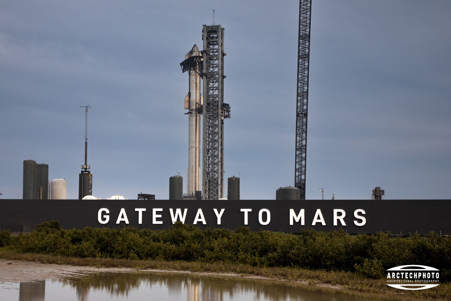 A gateway to mars sign with a rocket in the background
