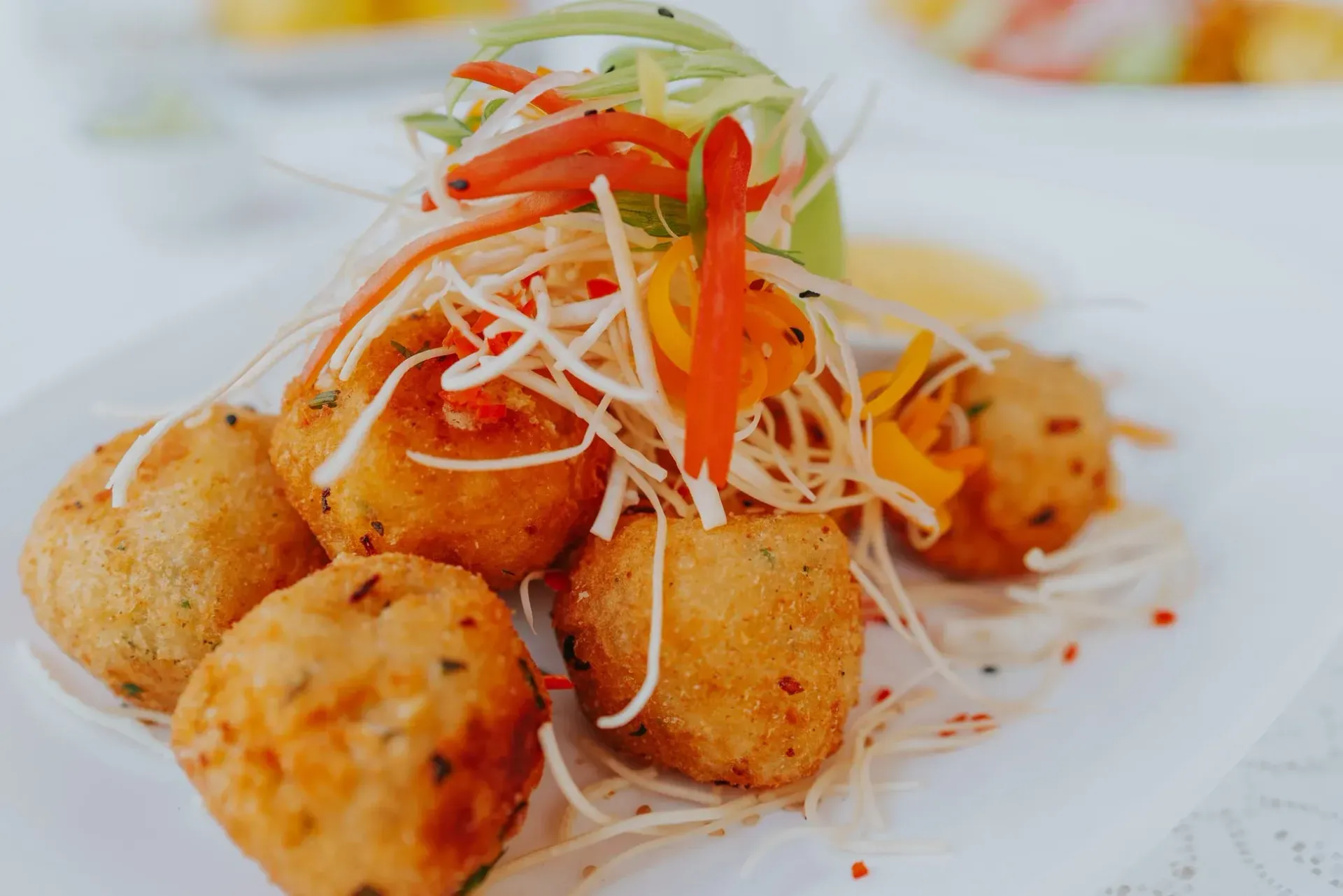 A close up of a plate of food with vegetables on a table.