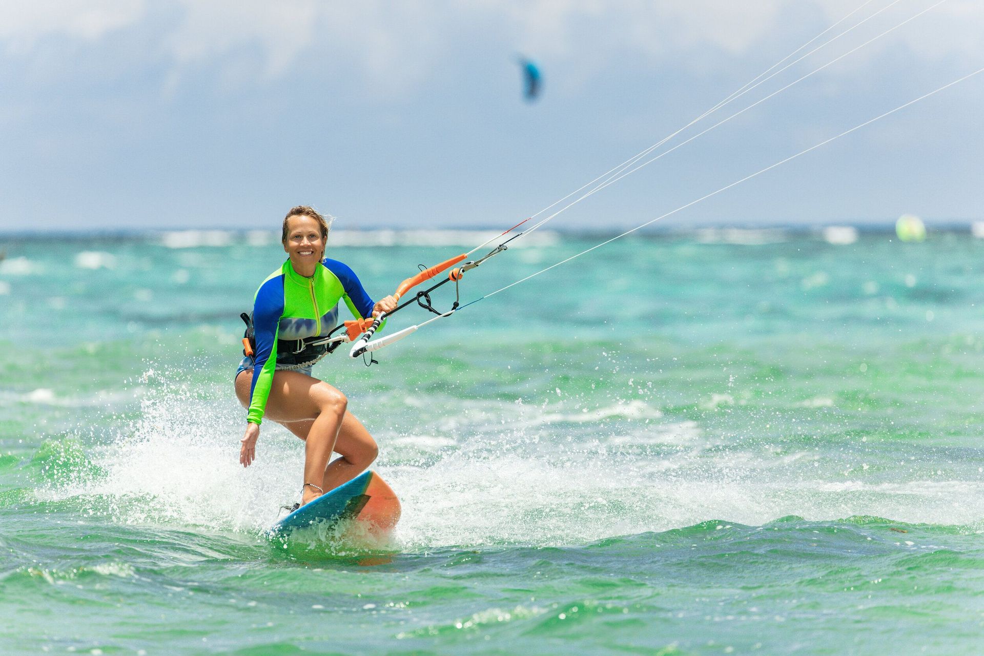 A woman is riding a wave on a surfboard in the ocean.