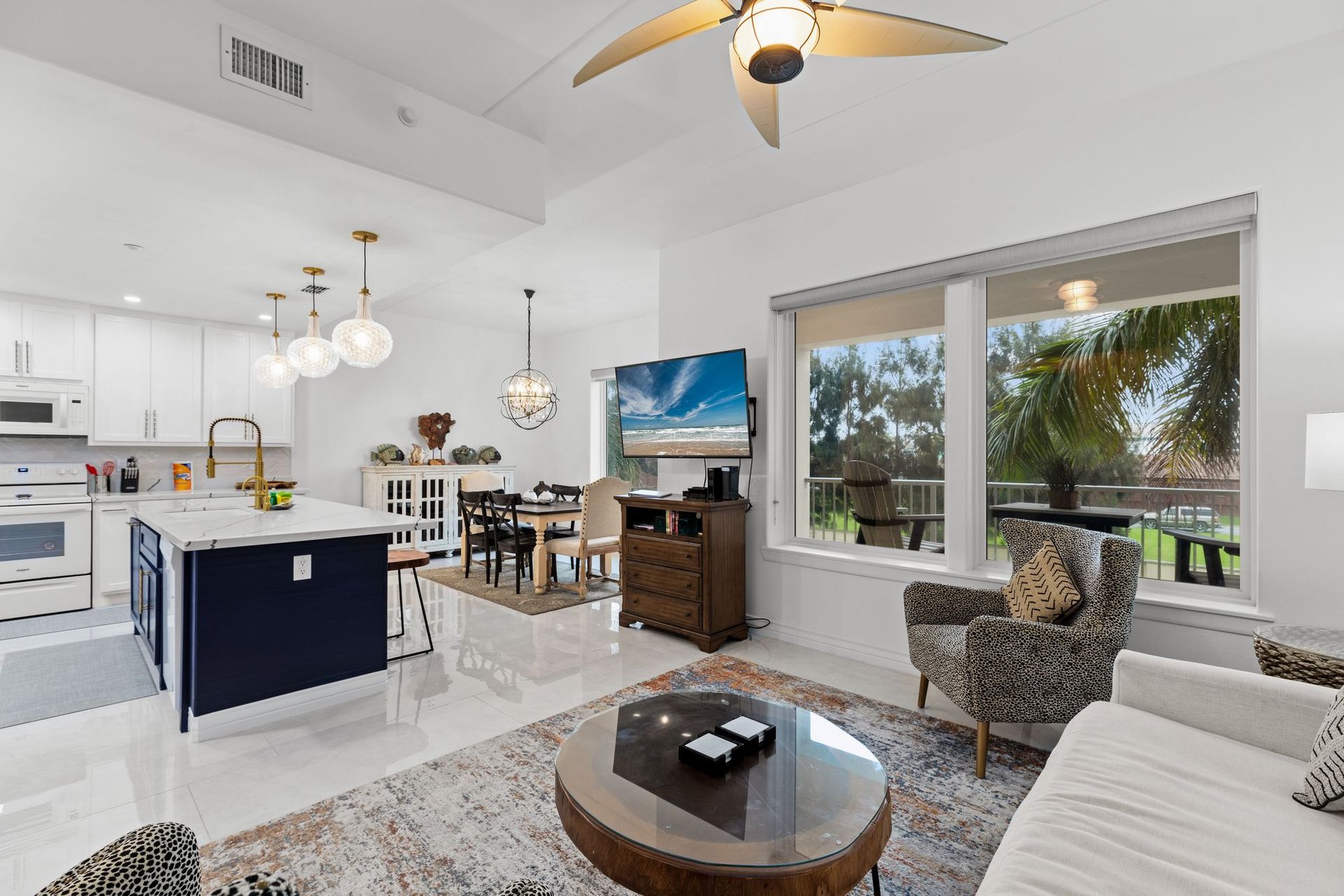 A living room filled with furniture and a ceiling fan.