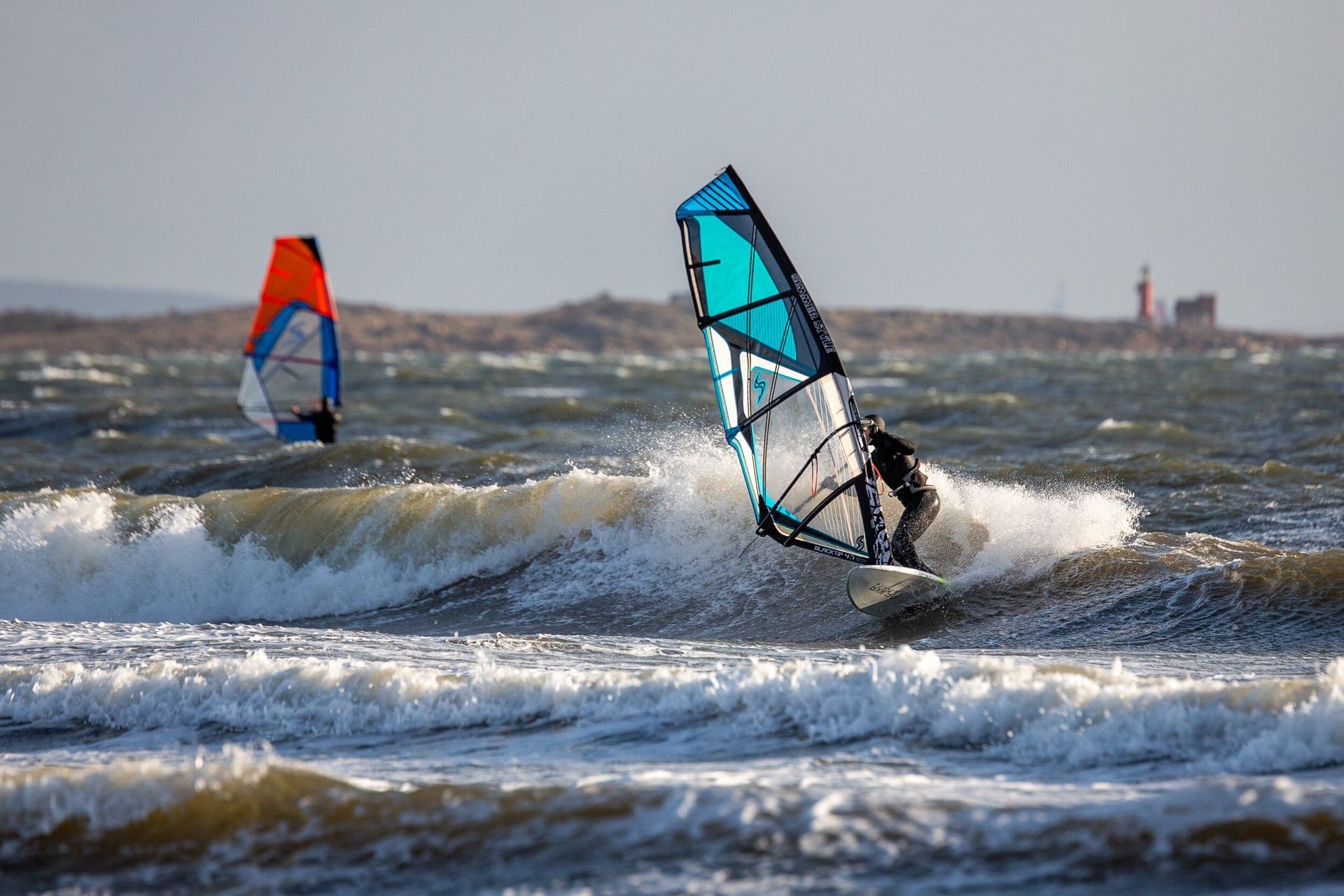 A person is riding a wave on a surfboard in the ocean.