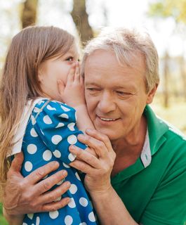 Hearing Aids — Girl Whispering To Her Grandfather in Richlands, VA