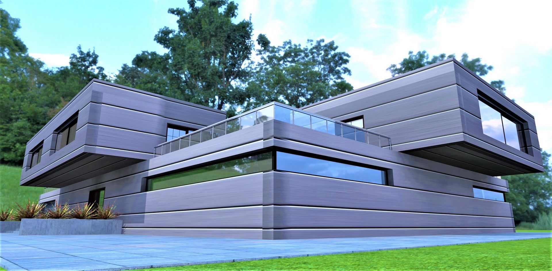 Moderna casa grigia con ampie finestre e balcone, immersa in un paesaggio verde.