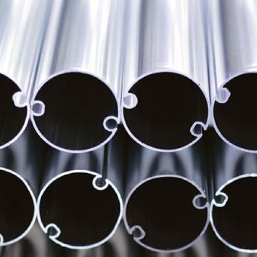 Primo piano di una pila di tubi di alluminio con estremità dentellate.