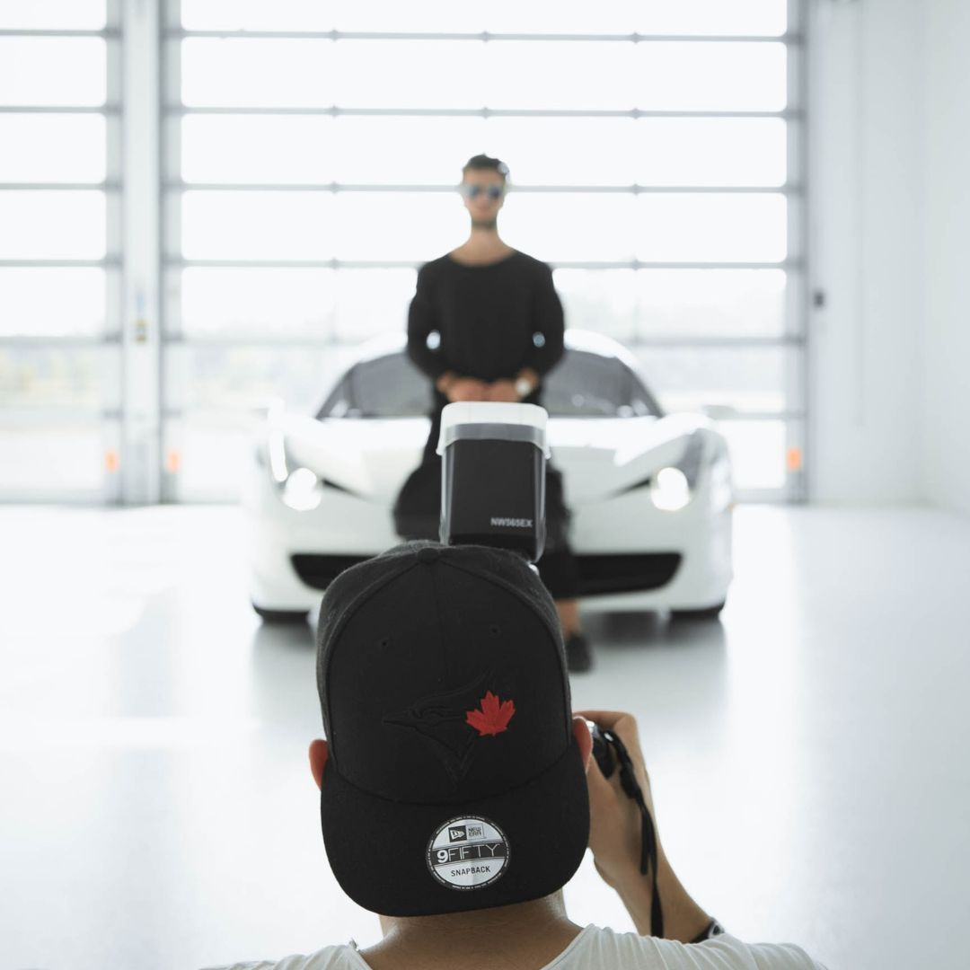 a person in front of a car getting recorded